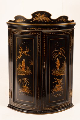 Lot 686 - A black and gold lacquered bowfronted corner...