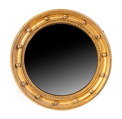 Lot 687 - A gilt framed convex mirror, in concave ball...