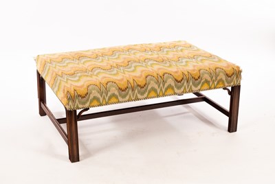 Lot 712 - A rectangular upholstered footstool on four...