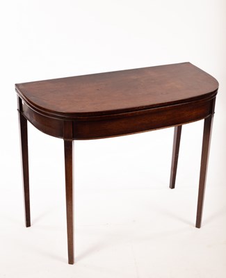 Lot 825 - A George III mahogany fold over card table, on...