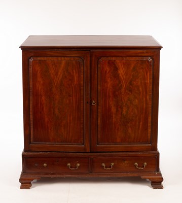 Lot 834 - A George III mahogany press cupboard enclosed...