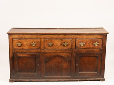 Lot 846 - An oak dresser base, three short drawers over...