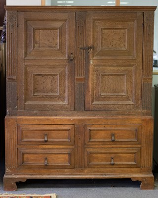 Lot 849 - A 20th Century oak cupboard, fielded panel...