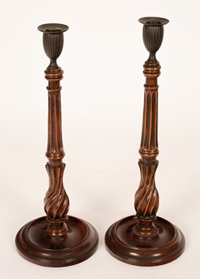 Lot 887 - A pair of George III mahogany candlesticks,...