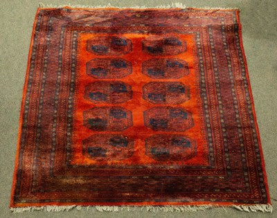 Lot 900 - A red Bokhara rug with blue details and...