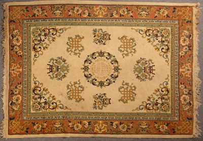 Lot 915 - A Chinese style wool carpet, the central...