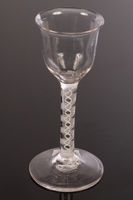 Lot 304 - An 18th Century wine glass, the lipped ogee...