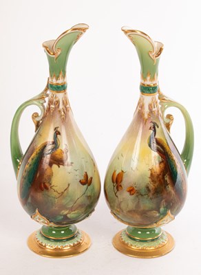 Lot 477 - Two Royal Worcester green-ground ewers painted...