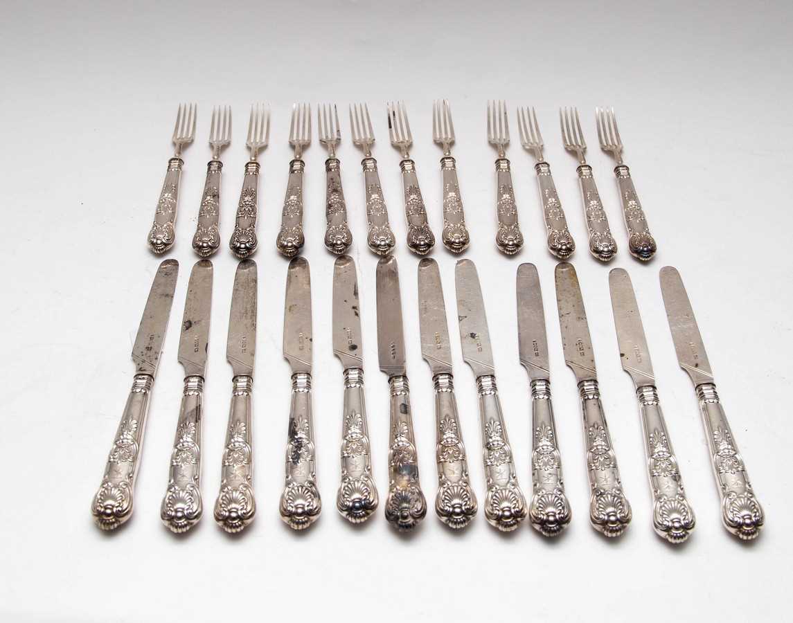 Lot 11 - A set of twelve silver desert knives and forks,...