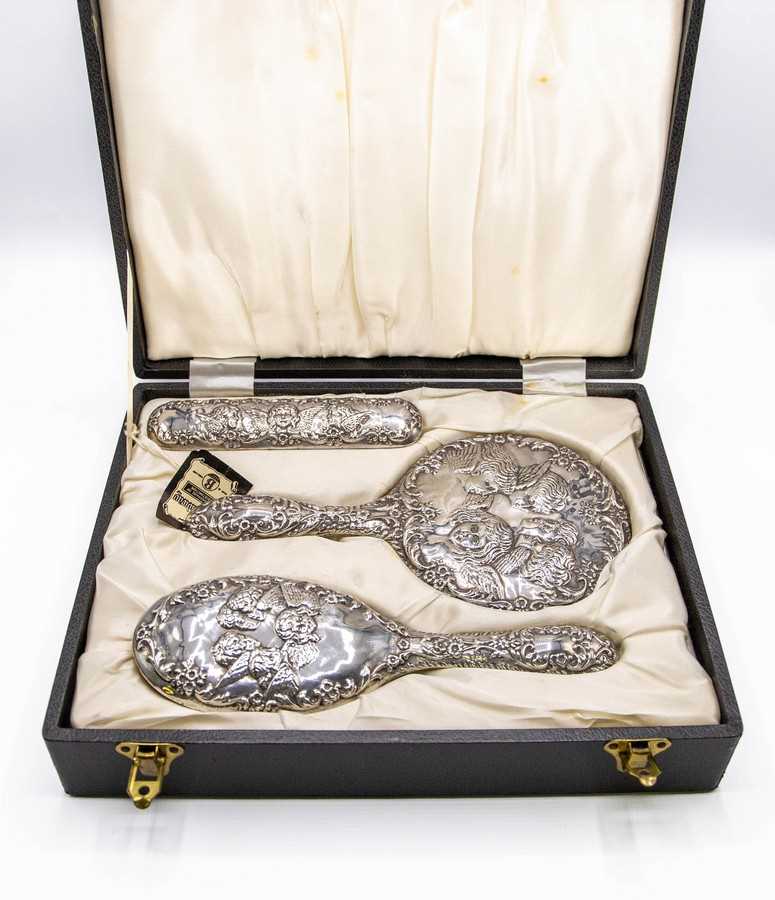 Lot 43 - A cased set of silver dressing brushes and...