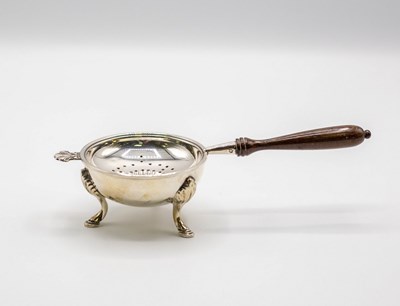 Lot 86 - A silver tea strainer, William Comyns & Sons...
