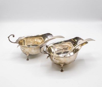 Lot 103 - A pair of Edwardian silver sauce boats, Asprey...