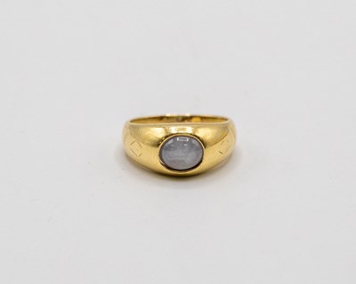 Lot 200 - An 18ct gold star sapphire ring, the oval...