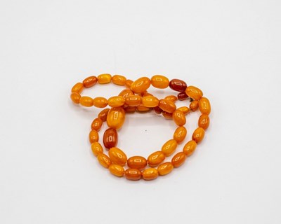 Lot 219 - A Baltic amber necklace of graduated oval...