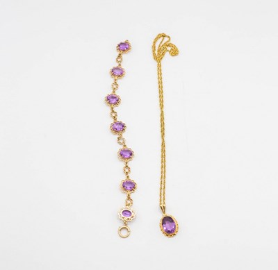 Lot 227 - An amethyst pendant on chain and an amethyst...