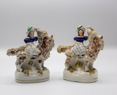 Lot 289 - Two Staffordshire figures of a girl riding a...