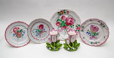 Lot 303 - Four pink flower painted faience plates, a...