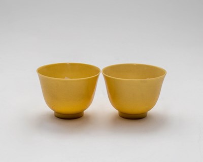 Lot 354 - A pair of Chinese yellow glazed tea cups, 20th...