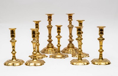 Lot 400 - A set of four 18th Century brass candlesticks...