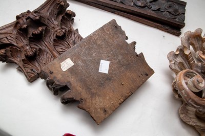 Lot 421 - A pair of carved wood capitals and three other...