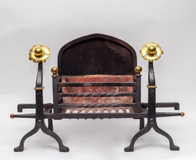 Lot 446 - An iron fire grate, the front with two brass...