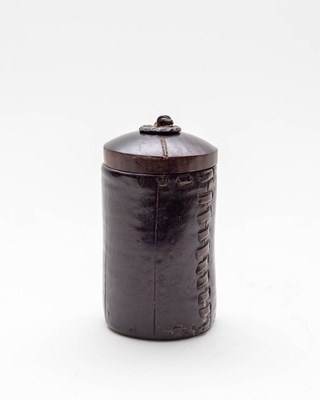 Lot 463 - A small leather pot, cylindrical with turned...