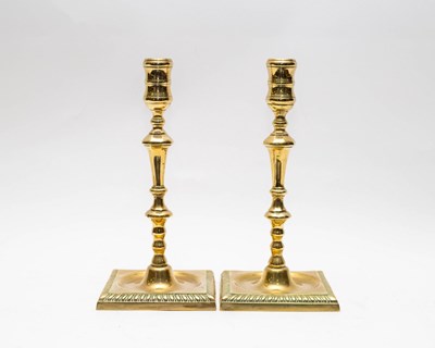 Lot 478 - A pair of 18th Century brass candlesticks on...