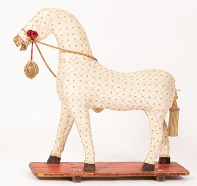 Lot 533 - A fabric covered toy horse on a stand, 73cm high