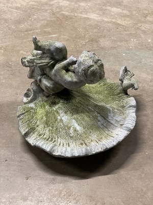 Lot 606 - A lead bird bath with shell bowl and cherub...