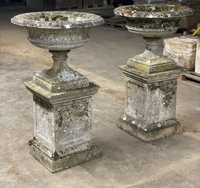 Lot 610 - A pair of well weathered reconstituted stone...