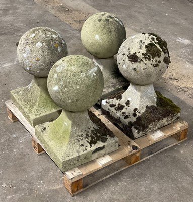 Lot 614 - A set of four reconstituted stone ball finials,...