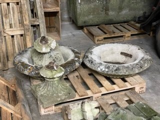 Lot 615 - A pair of well weathered reconstituted stone urns