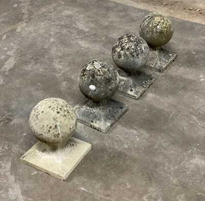 Lot 616 - A set of four reconstituted stone ball finials,...