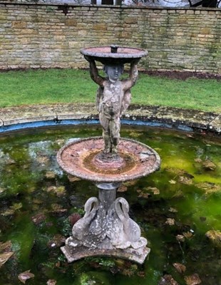 Lot 620 - A lead fountain with putto on swan support,...