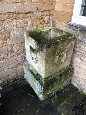 Lot 623 - A stone planter on plinth with wreath carved...