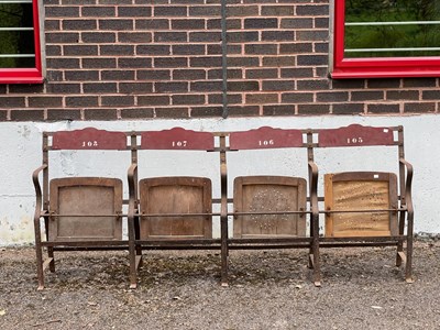 Lot 671 - A row of four 20th Century theatre seats, iron...