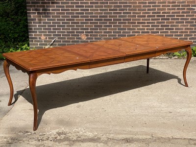 Lot 673 - A modern parquetry topped extending dining...