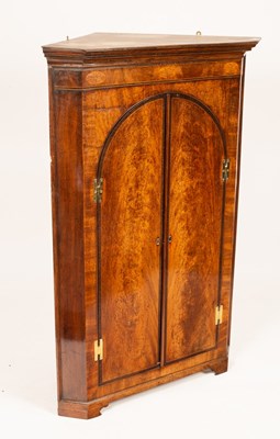 Lot 685 - A late 18th Century mahogany corner cupboard,...