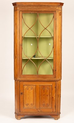 Lot 701 - A pine corner cupboard with glazed upper...