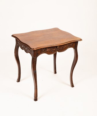 Lot 728 - A Continental oak side table with a shaped...