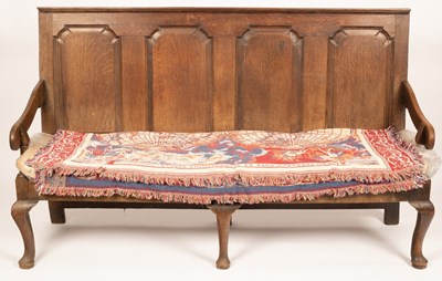 Lot 758 - An oak settle, with panelled back on cabriole...