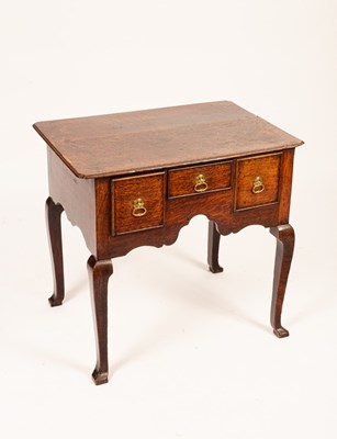 Lot 776 - A George II oak lowboy, the top with...