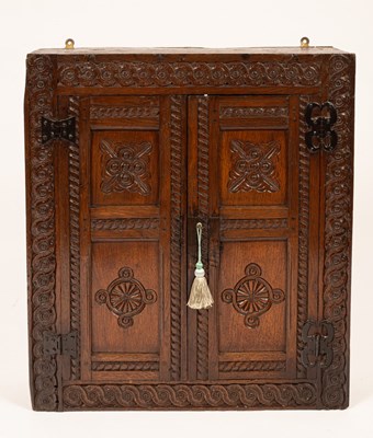 Lot 777 - An oak wall hanging cupboard, 17th Century and...