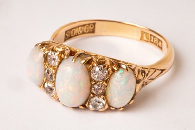 Lot 80 - An 18ct gold diamond and opal set ring, the...