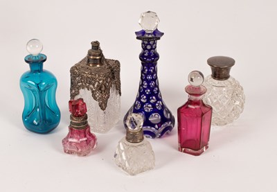 Lot 122 - Four silver mounted glass scent bottles and...