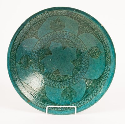 Lot 129 - A Persian turquoise glazed ceramic plate with...