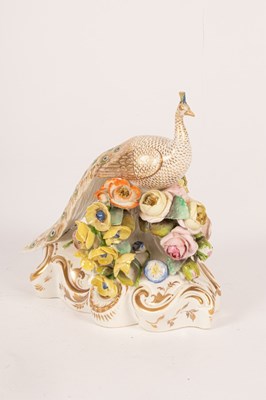 Lot 134 - A Bloor Derby figure of a peacock on a rococo...