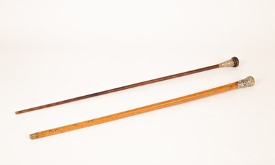 Lot 192 - Two cane walking sticks, both with silver...