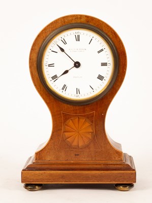 Lot 307 - A balloon-shaped mahogany mantel clock, the...