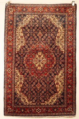 Lot 335 - A Sarouk rug, West Persia, the indigo field of...